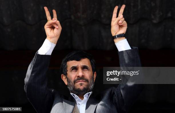 Iran's President Mahmoud Ahmadinejad flashes the V for 'victory' sign as he addresses thousands of people in the northeastern city of Bushehr, the...