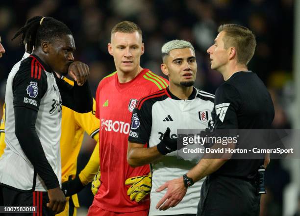 Fulham players arguing with the referee Michael Salisbury after awarding a penalty to Wolverhampton Wanderers during the Premier League match between...