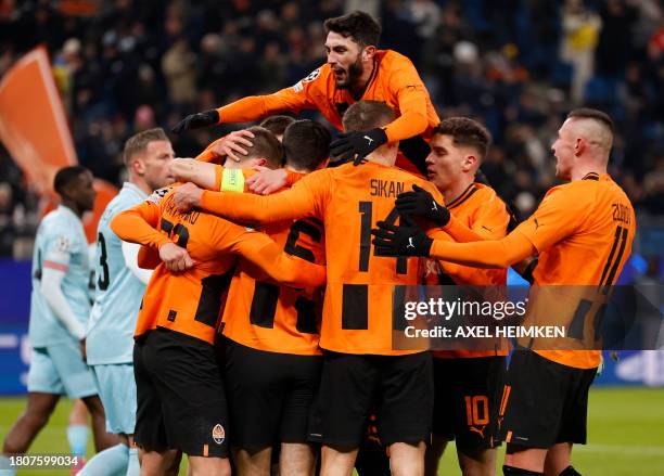 Shakhtar Donetsk's Ukrainian defender Mykola Matviyenko celebrates with teammates scoring the opening goal during the UEFA Champions League Group H...