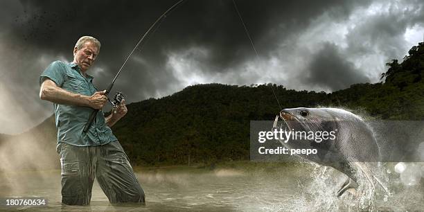 fisherman lands dangerous payara fish in amazon - fishing reel stock pictures, royalty-free photos & images