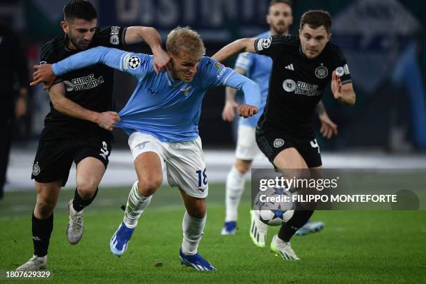 Lazio's Danish striker Gustav Isaksen fights for the ball with Celtic's Scottish defender Greg Taylor and Celtic's Scottish midfielder James Forrest...