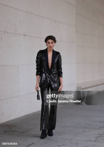 Sarah Posch seen wearing silver earrings, Karl Lagerfeld black sequins blazer jacket, matching Karl Lagerfeld black sequins long suit pants, Karl...