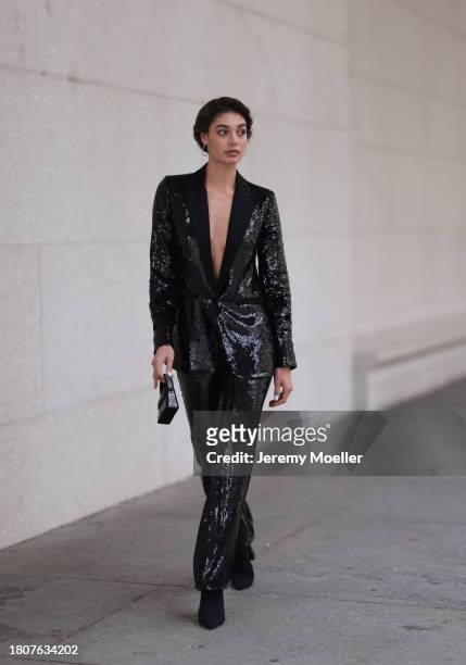Sarah Posch seen wearing silver earrings, Karl Lagerfeld black sequins blazer jacket, matching Karl Lagerfeld black sequins long suit pants, Karl...