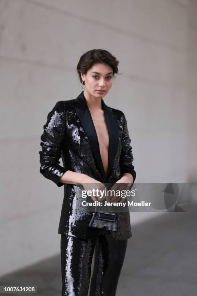 Sarah Posch seen wearing silver earrings, Karl Lagerfeld black sequins blazer jacket, matching Karl Lagerfeld black sequins long suit pants, Karl...