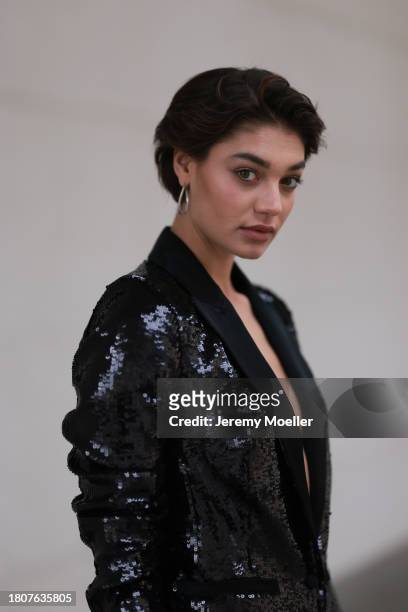 Sarah Posch seen wearing silver earrings, Karl Lagerfeld black sequins blazer jacket, on November 22, 2023 in Berlin, Germany.