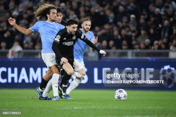 Lazio's French Midfielder Matteo Guendouzi fights for the ball with Celtic's Irish striker Michael Johnston during the UEFA Champions League Group E...