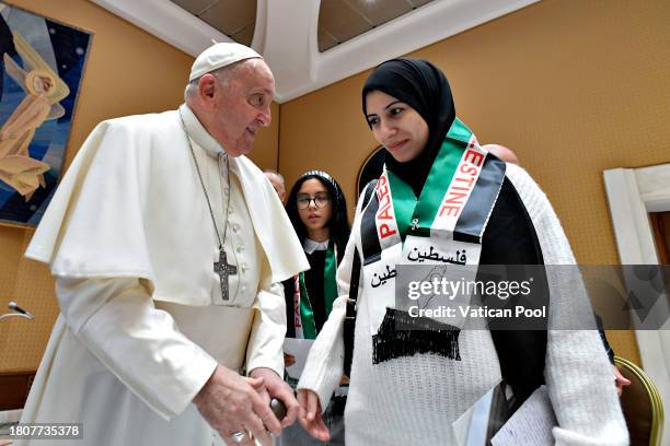 Pope Francis meets a delegation of families of Palestinians who are suffering in Gaza at the studio of Paul VI Hall on November 22, 2023 in Vatican...