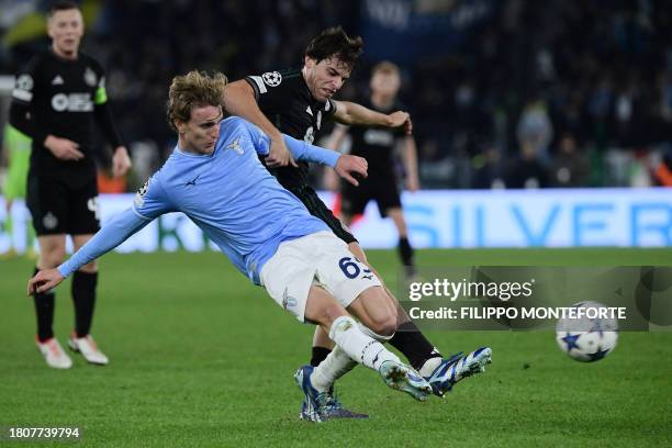 Celtic's Portuguese midfielder Paulo Bernardo fights for the ball with Lazio's Italian midfielder Nicolo Rovella during the UEFA Champions League...