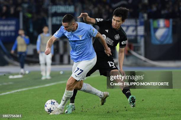 Celtic's South Korean striker Hyeon Jun Yang fights for the ball with Lazio's Montenegrin defender Adam Marusic during the UEFA Champions League...