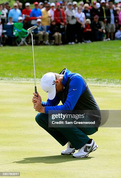 Nick Watney reacts to a missed birdie putt on the 18th green during the Final Round of the BMW Championship at Conway Farms Golf Club on September...