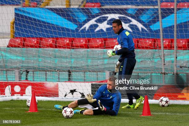 Bernd Leno of Bayer Leverkusen makes a save as Andres Palop looks on during a first team training session ahead of their UEFA Champions League match...