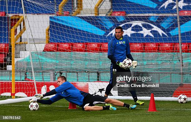 Bernd Leno of Bayer Leverkusen makes a save as Andres Palop looks on during a first team training session ahead of their UEFA Champions League match...