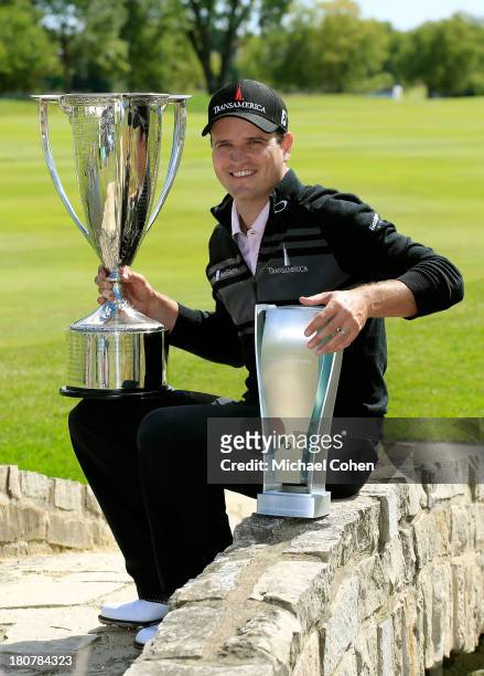 Zach Johnson poses with the J.K. Wadley Trophy and BMW Championship Trophy after winning the BMW Championship at Conway Farms Golf Club on September...