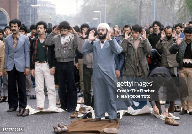 Iranians praying during the siege of the Iranian Embassy on Prince's Gate, South Kensington, London, circa May 1980.