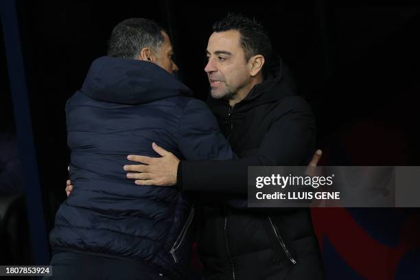 Porto's Portuguese coach Sergio Conceicao greets Barcelona's Spanish coach Xavi before the start of the UEFA Champions League first round group H...