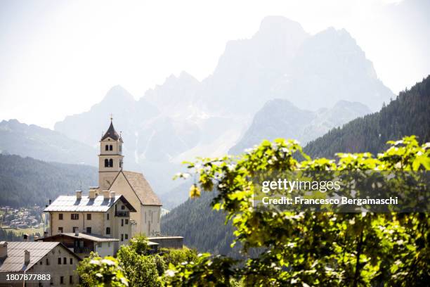 village of colle santa lucia with view on the monte pelmo in a foggy morning. val fiorentina, cadore, veneto, italy, europe. - colle santa lucia stock pictures, royalty-free photos & images