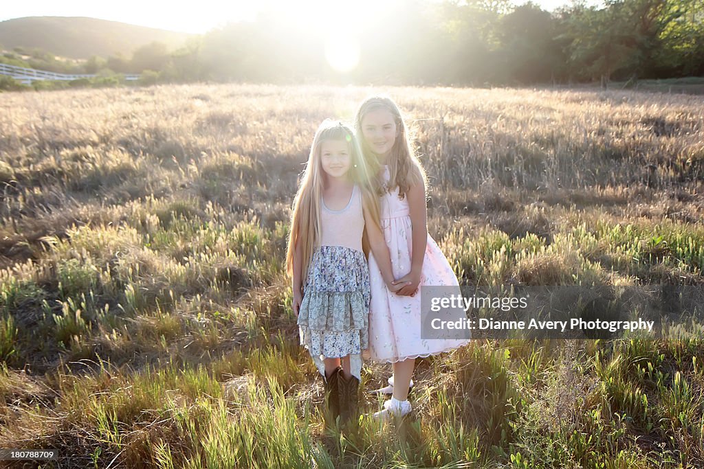 Sisters in sunny field