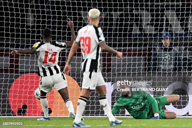 Newcastle United's Swedish striker Alexander Isak scores a goal against Paris Saint-Germain's Italian goalkeeper Gianluigi Donnarumma during the UEFA...