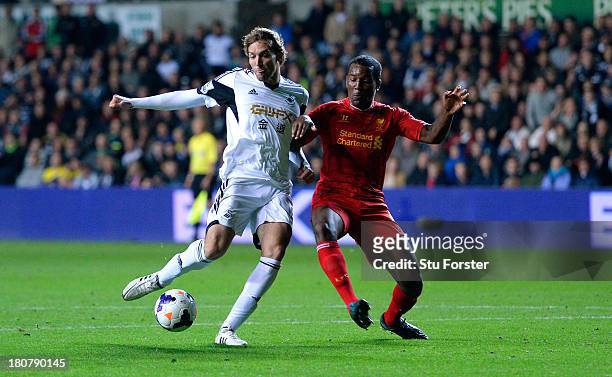 Swansea player Michu beats Andre Wisdom to the ball to score the second Swansea goal during the Barclays Premier League match between Swansea City...