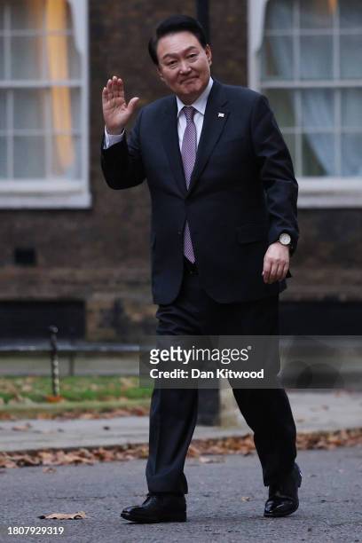 President of South Korea Yoon Suk Yeol waves as he arrives in Downing Street to meet Britain's Prime Minister Rishi Sunak and wife Akshata Murty...