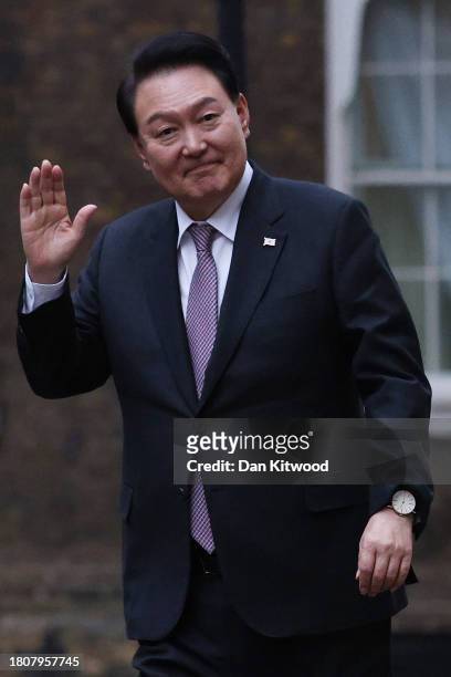 President of South Korea Yoon Suk Yeol waves as he arrives in Downing Street to meet Britain's Prime Minister Rishi Sunak and wife Akshata Murty...