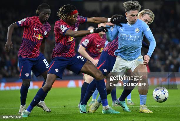 Leipzig's French defender Mohamed Simakan views with Manchester City's English midfielder Jack Grealish during the UEFA Champions League Group G...