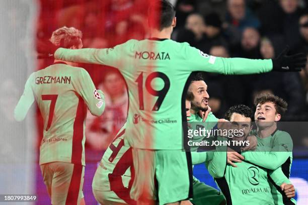 Atletico Madrid's Spanish defender Mario Hermoso celebrates with teammates after scoring his team's second goal during the UEFA Champions League...