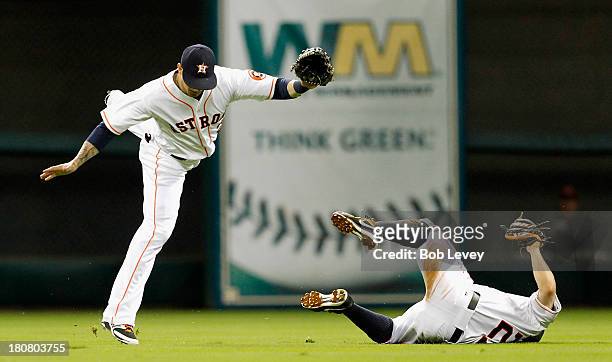 Brandon Barnes of the Houston Astros avoids colliding with Jose Altuve of the Houston Astros who makes an over the shoulder catch in the fifth inning...