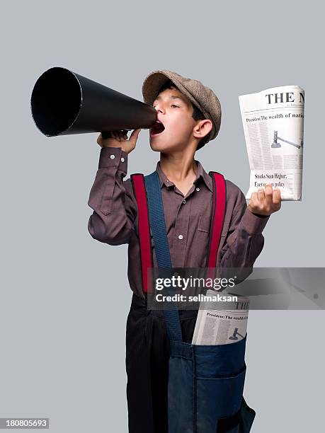 little newsboy holding newspapers and shouting with megaphone to sell - newspaper boy stock pictures, royalty-free photos & images