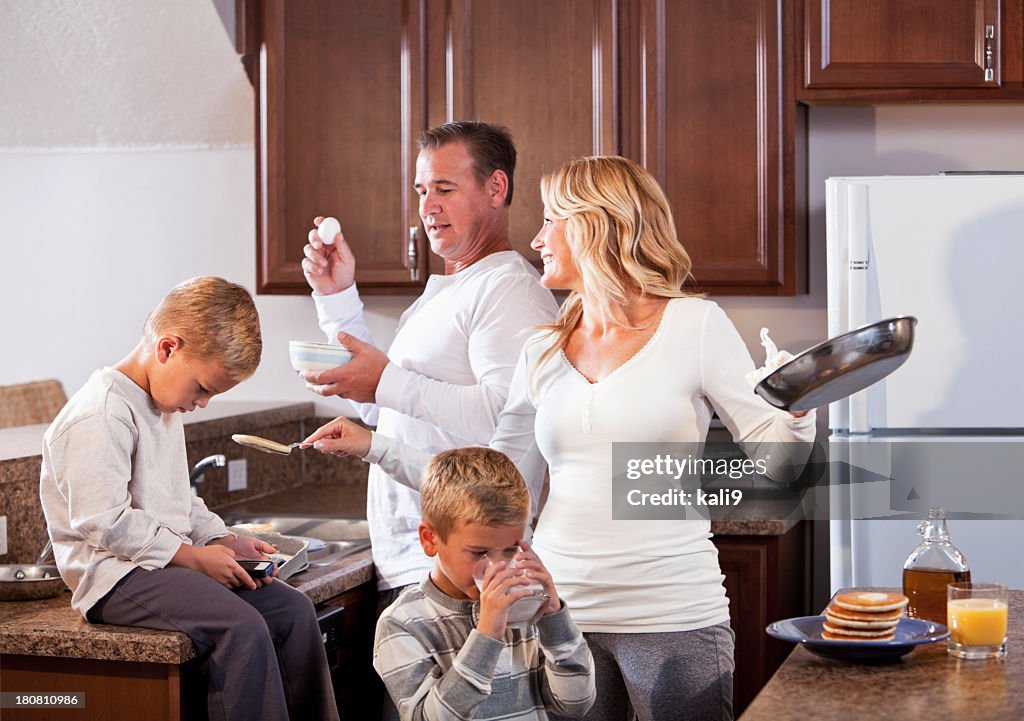 Family in kitchen making breakfast