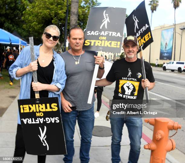 Kristen Johnston, Chris Bauer and Sam Trammell are seen picketing as the SAG-AFTRA Strike Continues on November 07, 2023 at Warner Bros. Studios in...