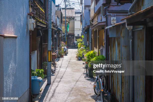 japan quiet residential homes alley plants bicycles cityscape osaka - alley stock pictures, royalty-free photos & images