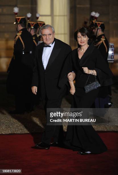 French former Prime minister Jean-Pierre Raffarin arrives with his wife Anne-Marie at the Elysee Palace to attend an official dinner with French...