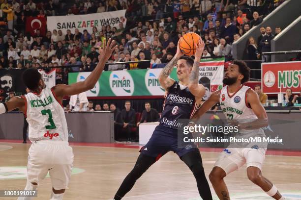 Errick McCollum , Darrun Hillard of Pinar Karsiyaka and Paul Lacombe of Strasbourg battle for the ball during the FIBA Champions League Basketball...