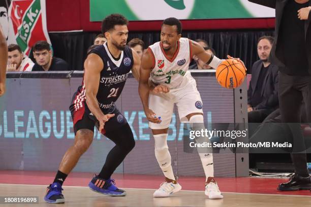 Errick McCollum of Pinar Karsiyaka and Quinton Hooker of Strasbourg battle for the ball during the FIBA Champions League Basketball match between...