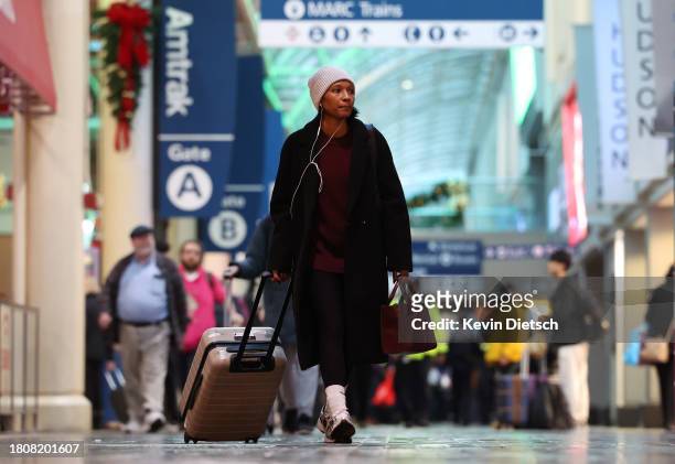 Traveler walks through Union Station on November 22, 2023 in Washington, DC. Flights, highways, trains, and other forms of transportation are...