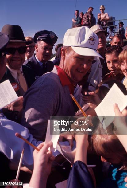Arnold Palmer signs autographs during the 1964 Masters Tournament at Augusta National Golf Club in April, 1964 in Augusta, Georgia.