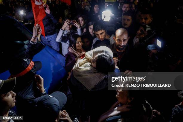 Newly released Palestinian prisoner Rouba Assi hugs a relative during a welcome ceremony following the release of prisoners from Israeli jails in...