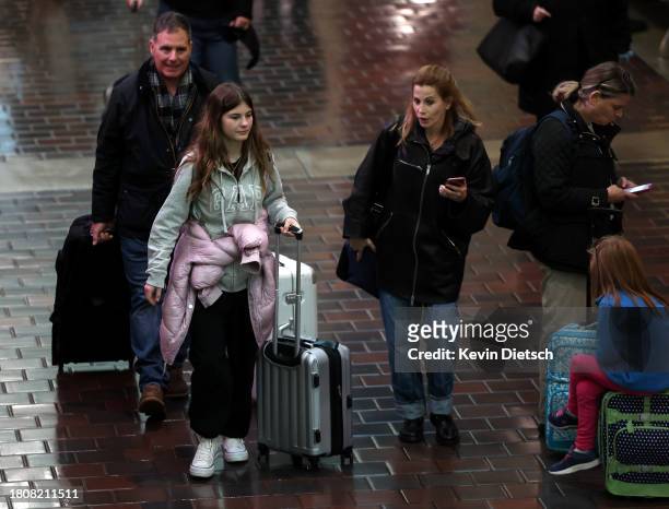 Travelers walk through Union Station on November 22, 2023 in Washington, DC. Flights, highways, trains, and other forms of transportation are...