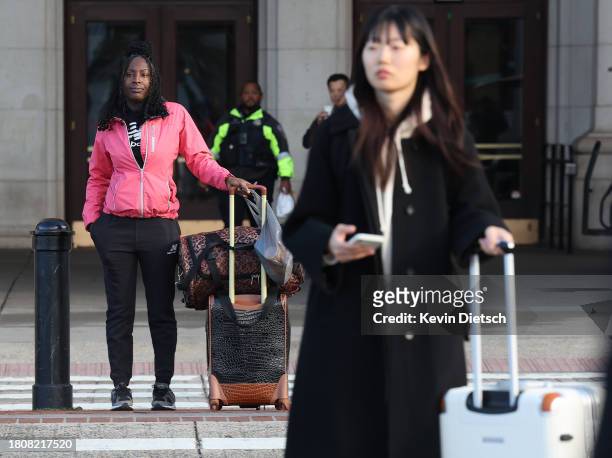Travelers wait outside of Union Station on November 22, 2023 in Washington, DC. Flights, highways, trains, and other forms of transportation are...