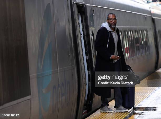 Traveler gets off an Amtrak train as it arrives at Union Station on November 22, 2023 in Washington, DC. Flights, highways, trains and other forms of...