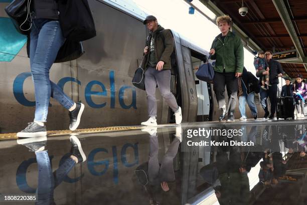 Travelers get off an Amtrak train at Union Station on November 22, 2023 in Washington, DC. Flights, highways, trains, and other forms of...