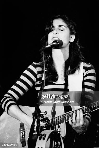 American Folk, Pop, and Rock musician Karla Bonoff plays acoustic guitar as she performs onstage at Greenwich Village's Bottom Line, New York, New...