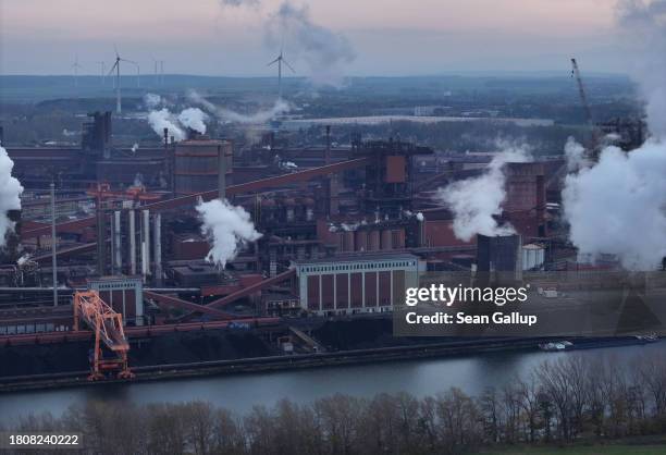 In this aerial view coal transported by barge lies deposited as water vapour and exhaust rise from the steel mill of Salzgitter AG, one Europe's...