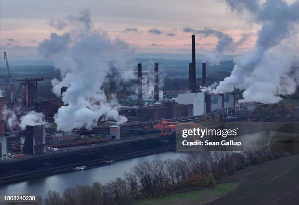 In this aerial view coal transported by barge lies deposited as water vapour and exhaust rise from the steel mill of Salzgitter AG, one Europe's...