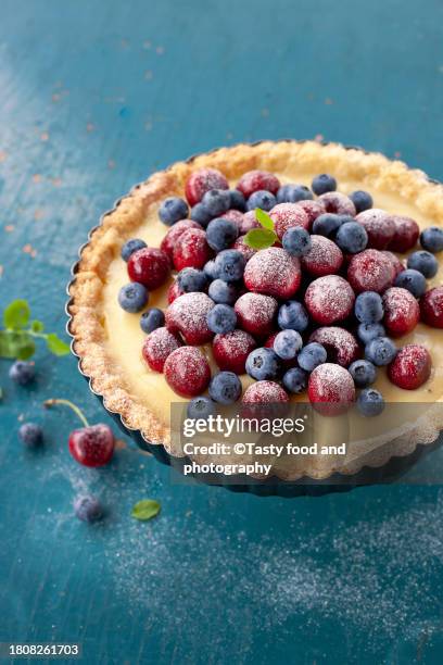 custard tart stuffed with red cherry and blueberry - blueberry pie stock pictures, royalty-free photos & images