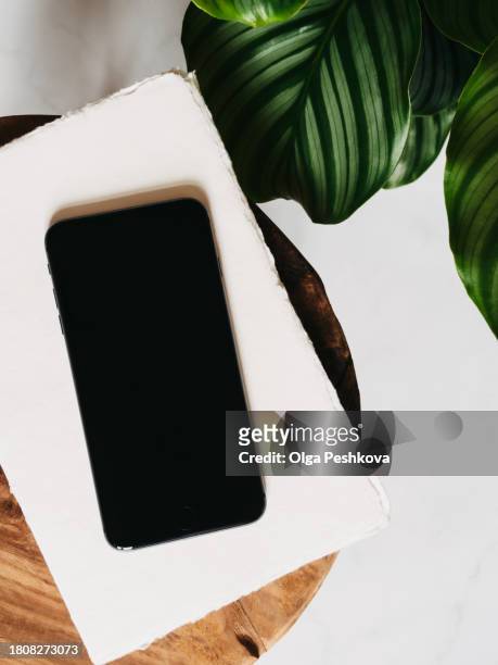 flat lay of black smartphone with screen mock up - magazine mockup stock pictures, royalty-free photos & images