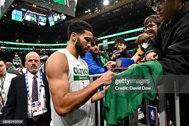 Jayson Tatum of the Boston Celtics signs autograph during half time against the New York Knicks on November 13, 2023 at the TD Garden in Boston,...