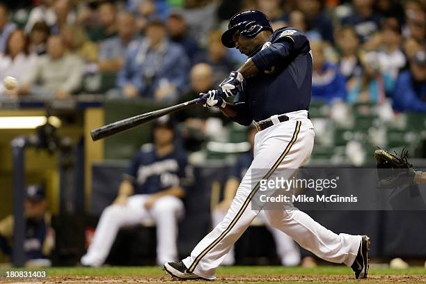 Yuniesky Betancourt of the Milwaukee Brewers hits a double, scoring Caleb Gindl in the bottom of the sixth inning against the Chicago Cubs at Miller...