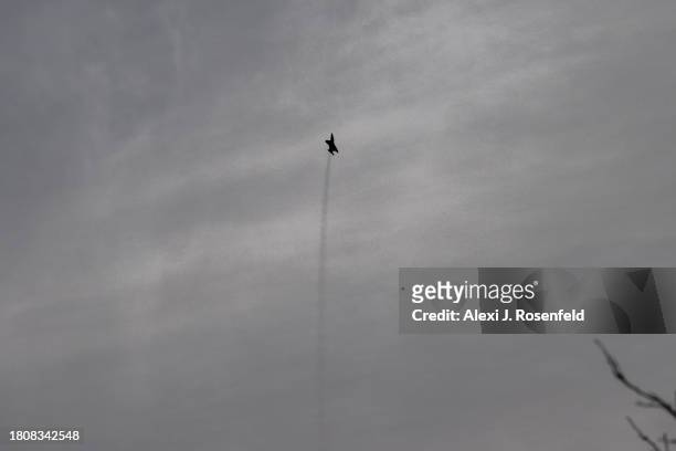 An Israeli Air Force fighter jet flies near the outskirts of Beer Sheva on November 22, 2023 in Southern Israel. More than a month after Hamas's Oct....